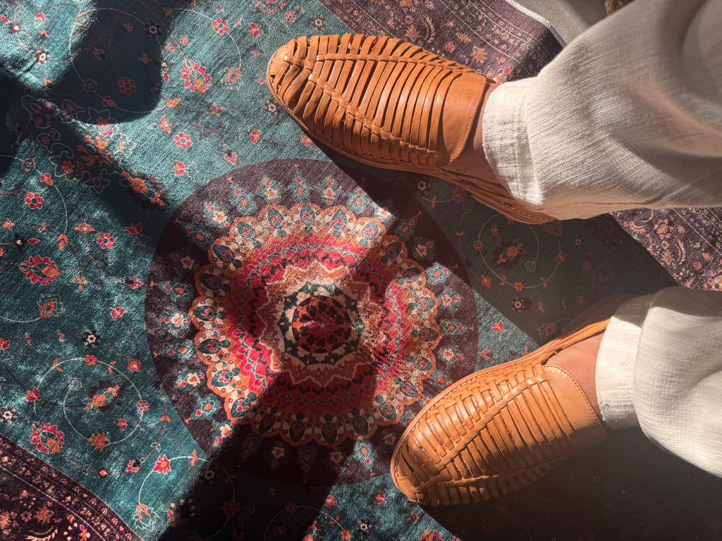 Light brown loafers on a patterned rug